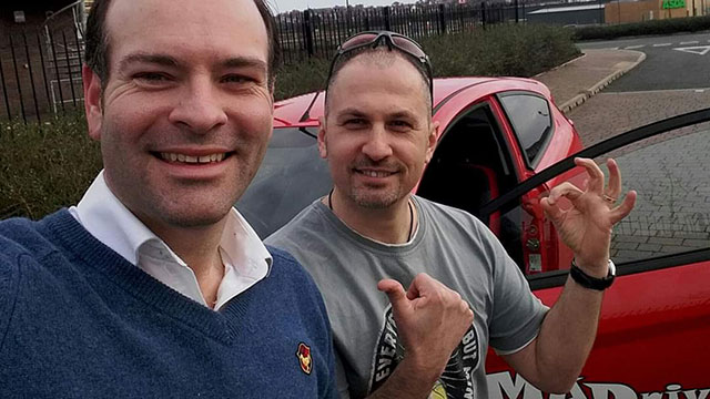 Learner giving Mike a thumbs-up after passing