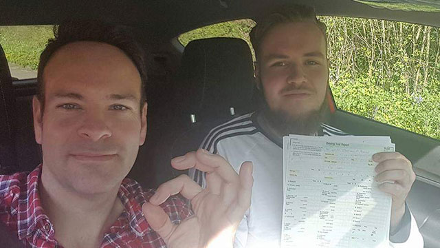 Learner showing their practical driving test pass certificate