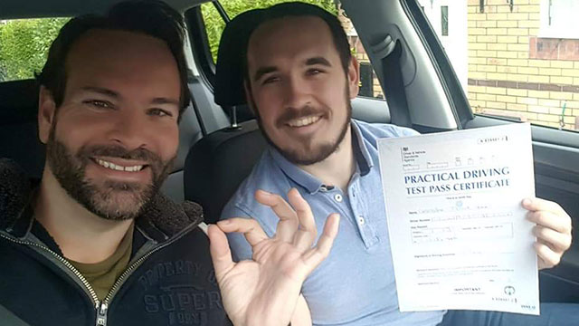 Learner showing their practical driving test pass certificate