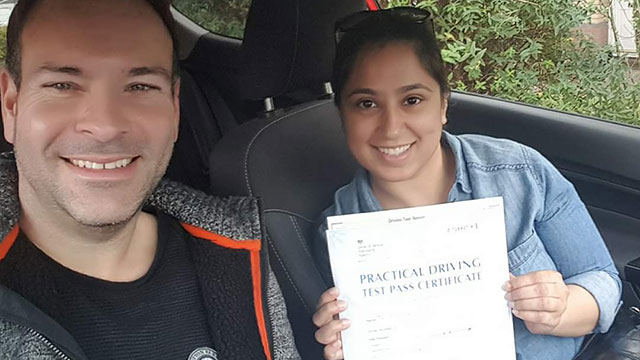 Learner showing their practical driving test pass certificate