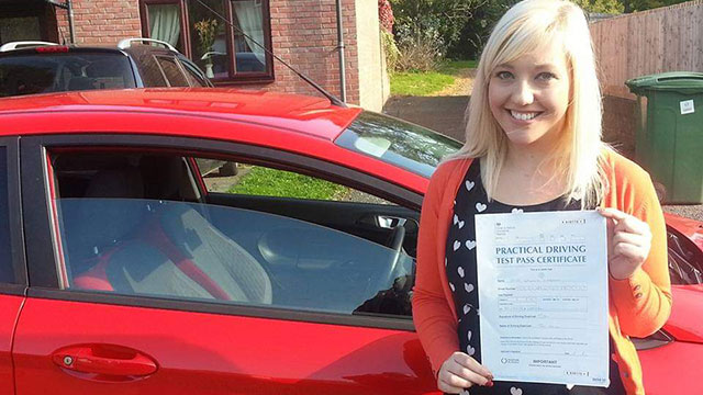 Learner showing their practical driving test pass certificate