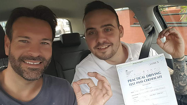Learner showing their practical driving test pass certificate