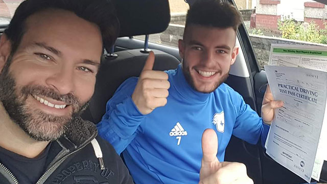 Learner showing their practical driving test pass certificate